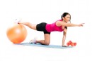 Girl on the exercise mat with a ball 